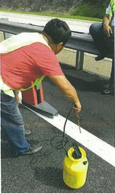 Technician testing road marking retroreflectivity with a Delta LTX Z retroreflectometer