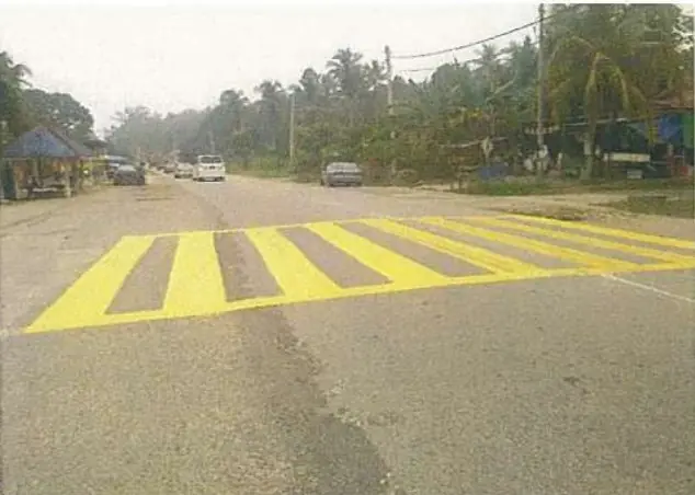 Yellow pedestrian crossing stripes on a road